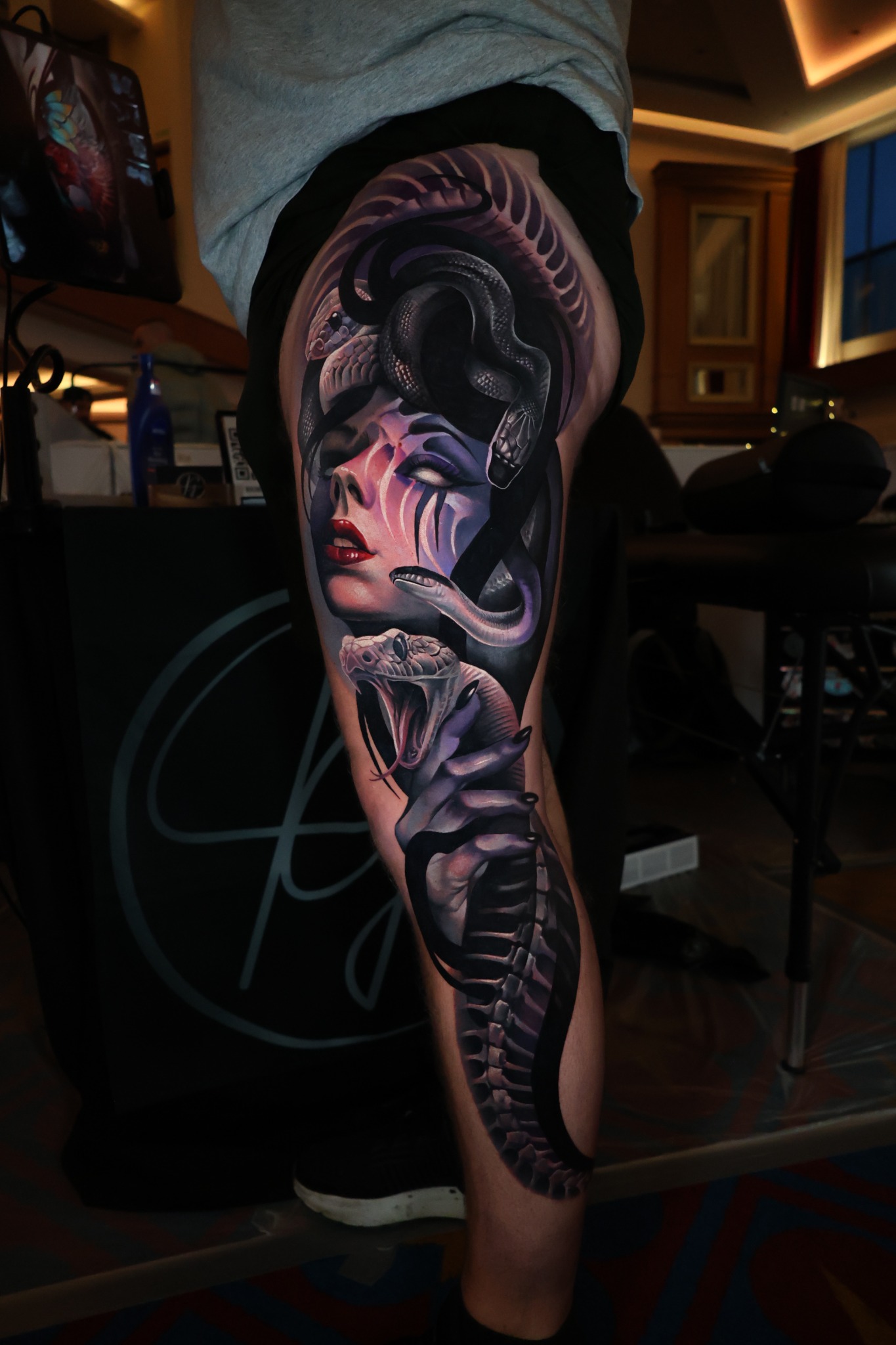 Purple and black snake woman tattoo